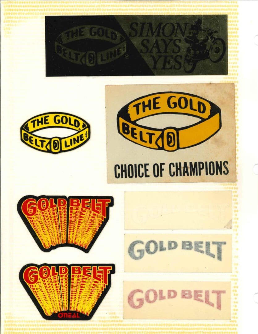 A collection of gold belts and stickers.
