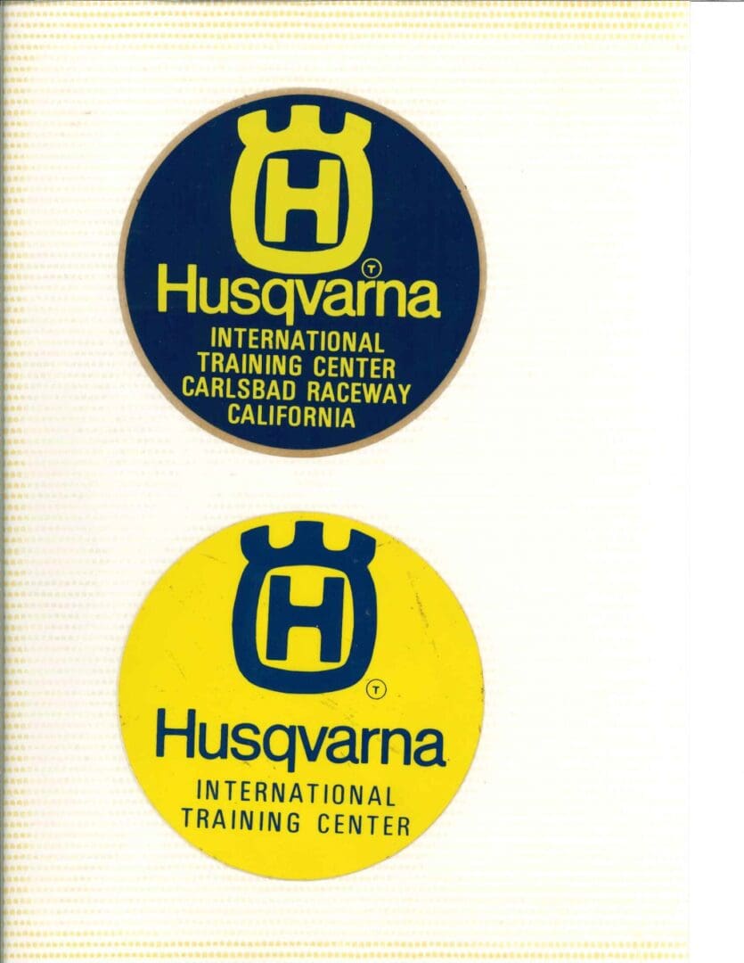 Two yellow and blue stickers with the words husqvarna international training center.