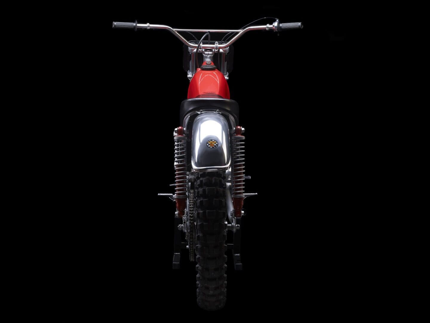 A red dirt bike on a black background.