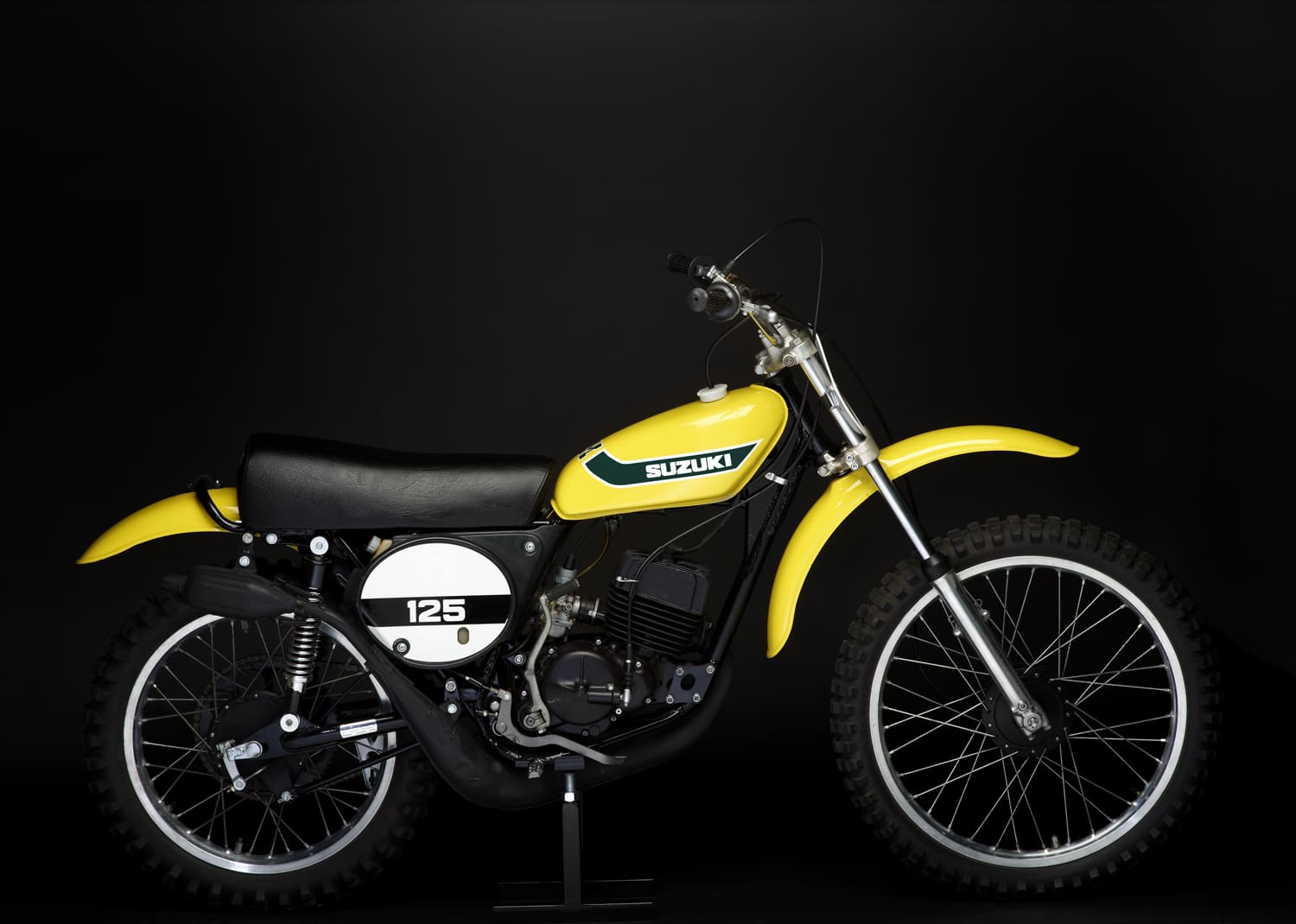 A yellow dirt bike, perfect for MX Motorbikes enthusiasts, sits confidently on a sleek black background.
