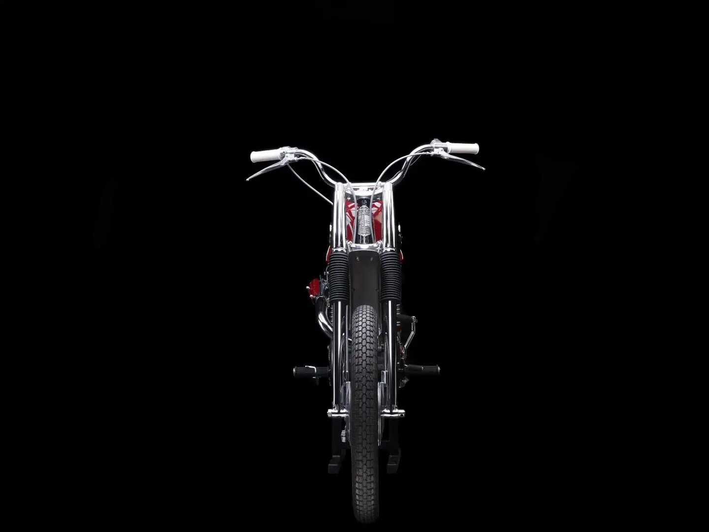 Red and silver bike on black background