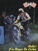 A man riding a vintage dirt bike in front of a crowd, showcasing his skills to the astonishment of onlookers.