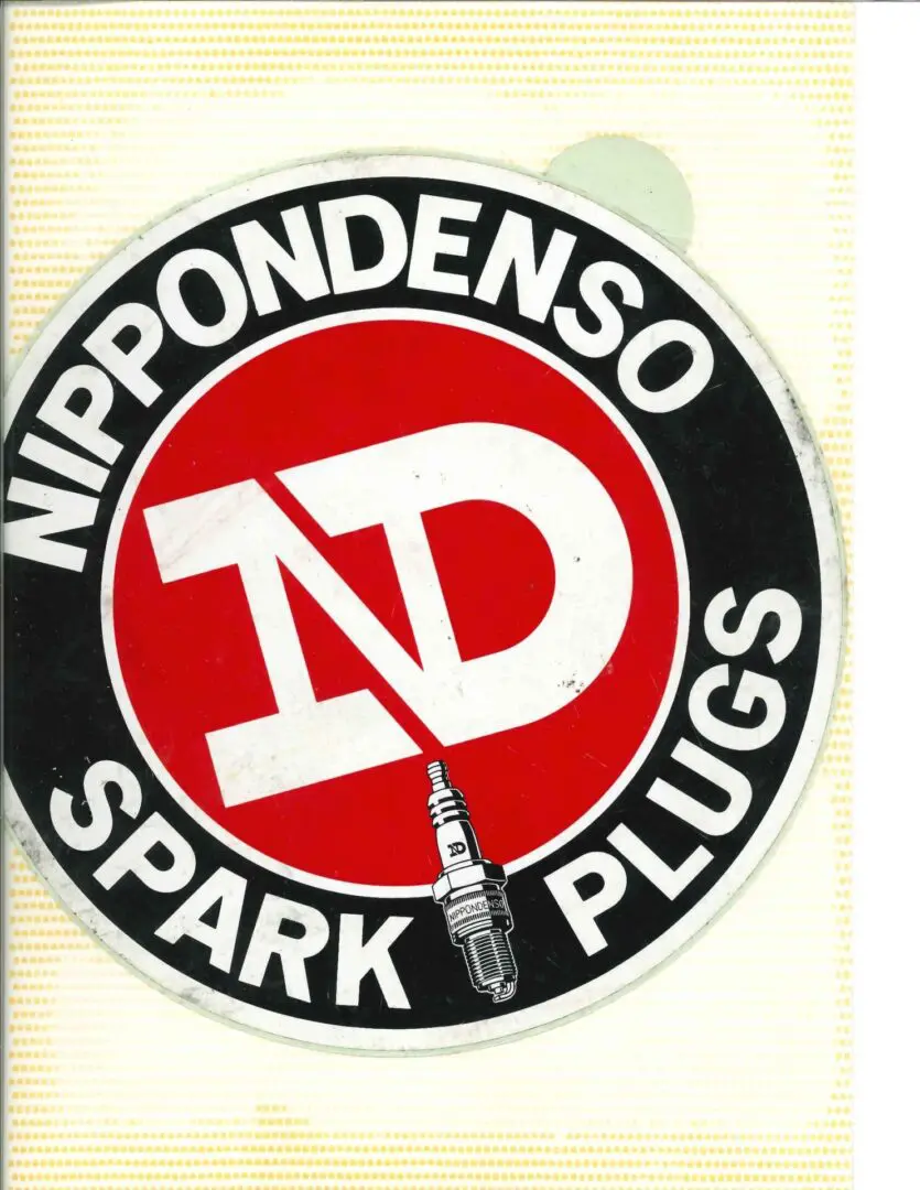 A sticker with the words nippondenso spark plugs.