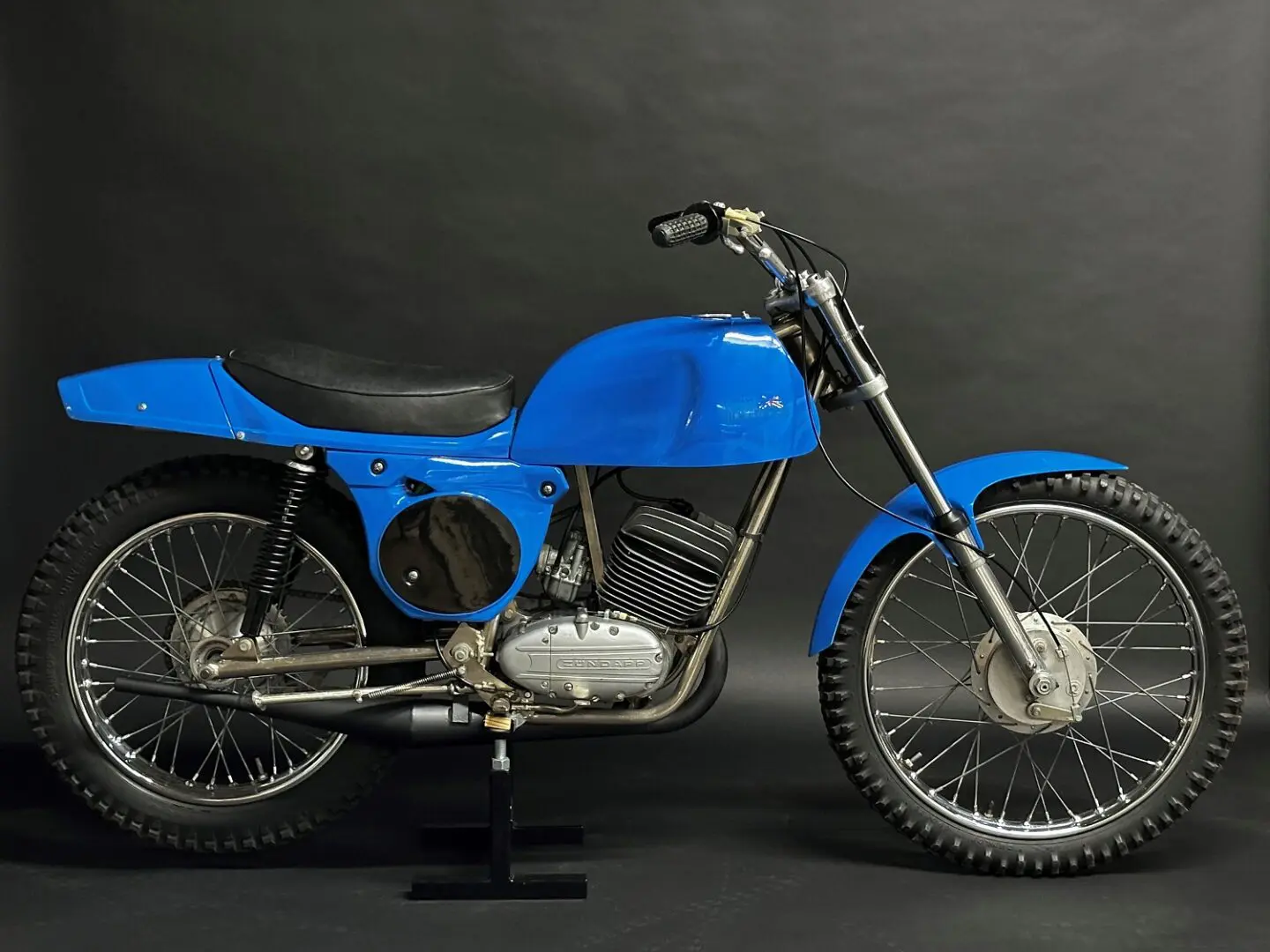 A Blue Color Bike With a Single Seat Image Other Side