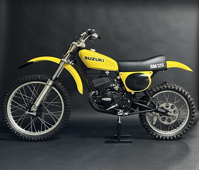 Yellow Suzuki RM125 dirt bike on stand